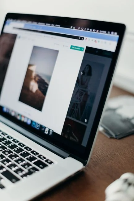 A sleek office desk setup featuring Apple devices: iMac, MacBook, and iPad.