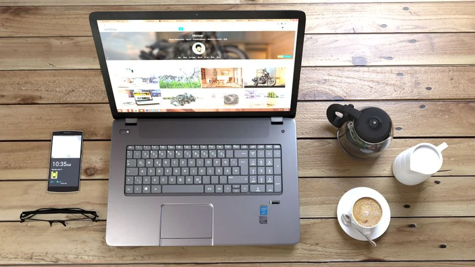 A modern workspace featuring dual computer monitors displaying web design projects, emphasizing technology and productivity.