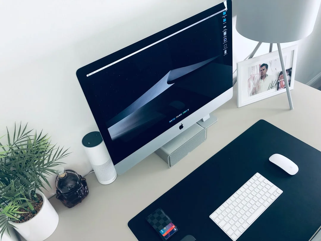A laptop on a bed showing web design software, creating a cozy workspace.